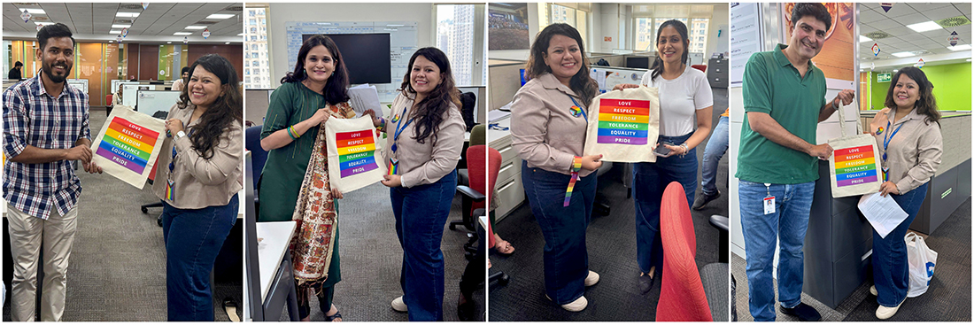 Mini Pride Walk inside the office- Alt text: People in pairs holding a rainbow flag, all smiling and celebrating.